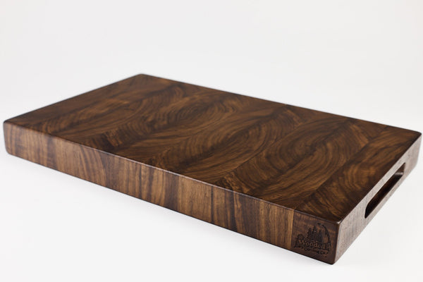 Wooden cutting board with a visible brand logo on a white background