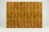Wooden cutting board with a checkered pattern on a white background