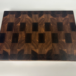Thick Walnut end grain cutting board with a visible brand logo on a white background, top down photo