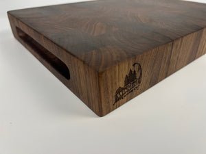 Wooden cutting board with engraved design on a white background