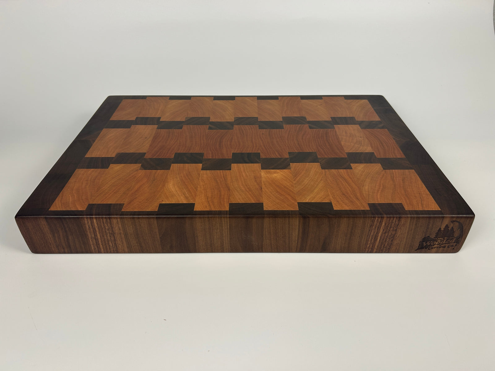 Wooden cutting board with apples and a knife on a dark surface