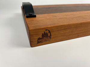 Wooden cutting board with a metal handle on a white background