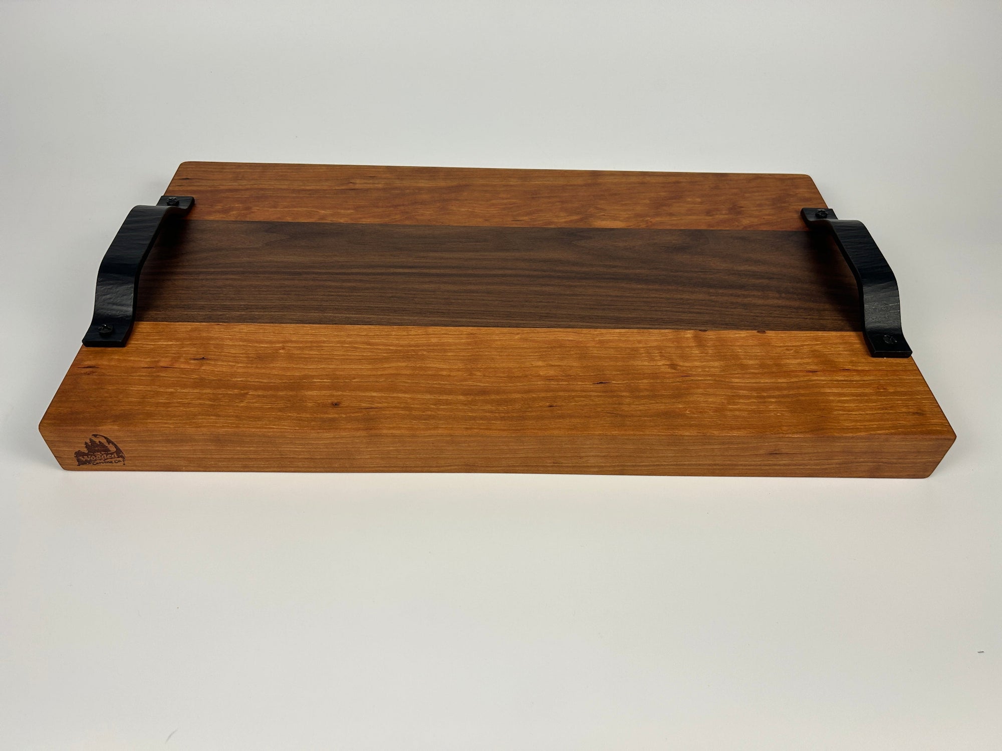 Wooden tray with black handles on a white background
