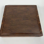 Wooden walnut cutting board on a white background