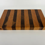 Wooden cutting board with striped pattern on a white background