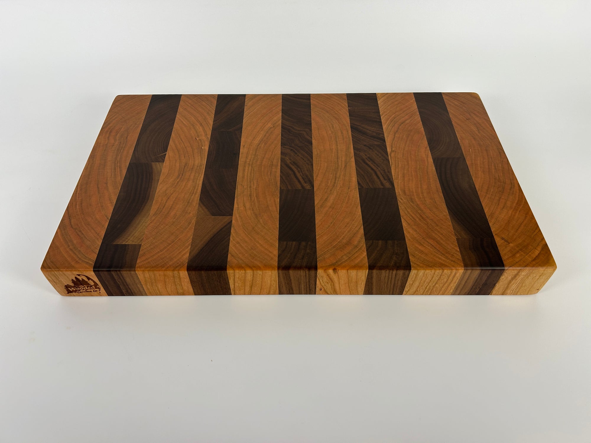 Wooden cutting board with striped pattern on a white background