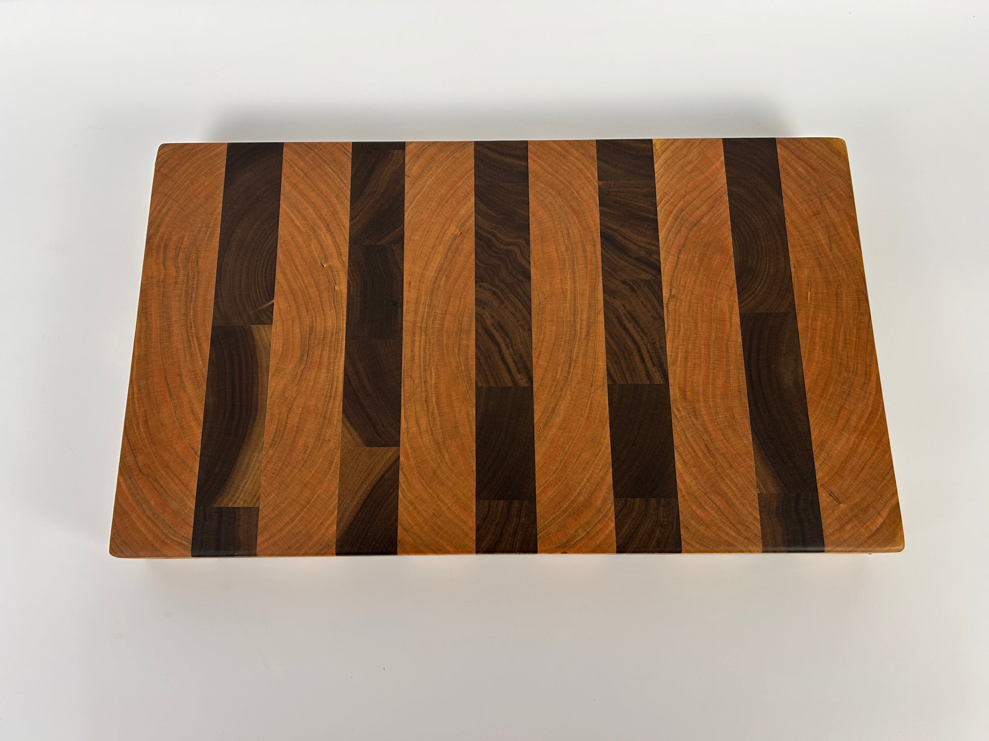 Wooden cutting board with striped pattern on a white background