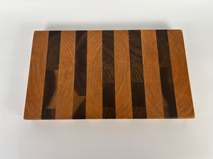 Wooden cutting board with a striped pattern on a white background