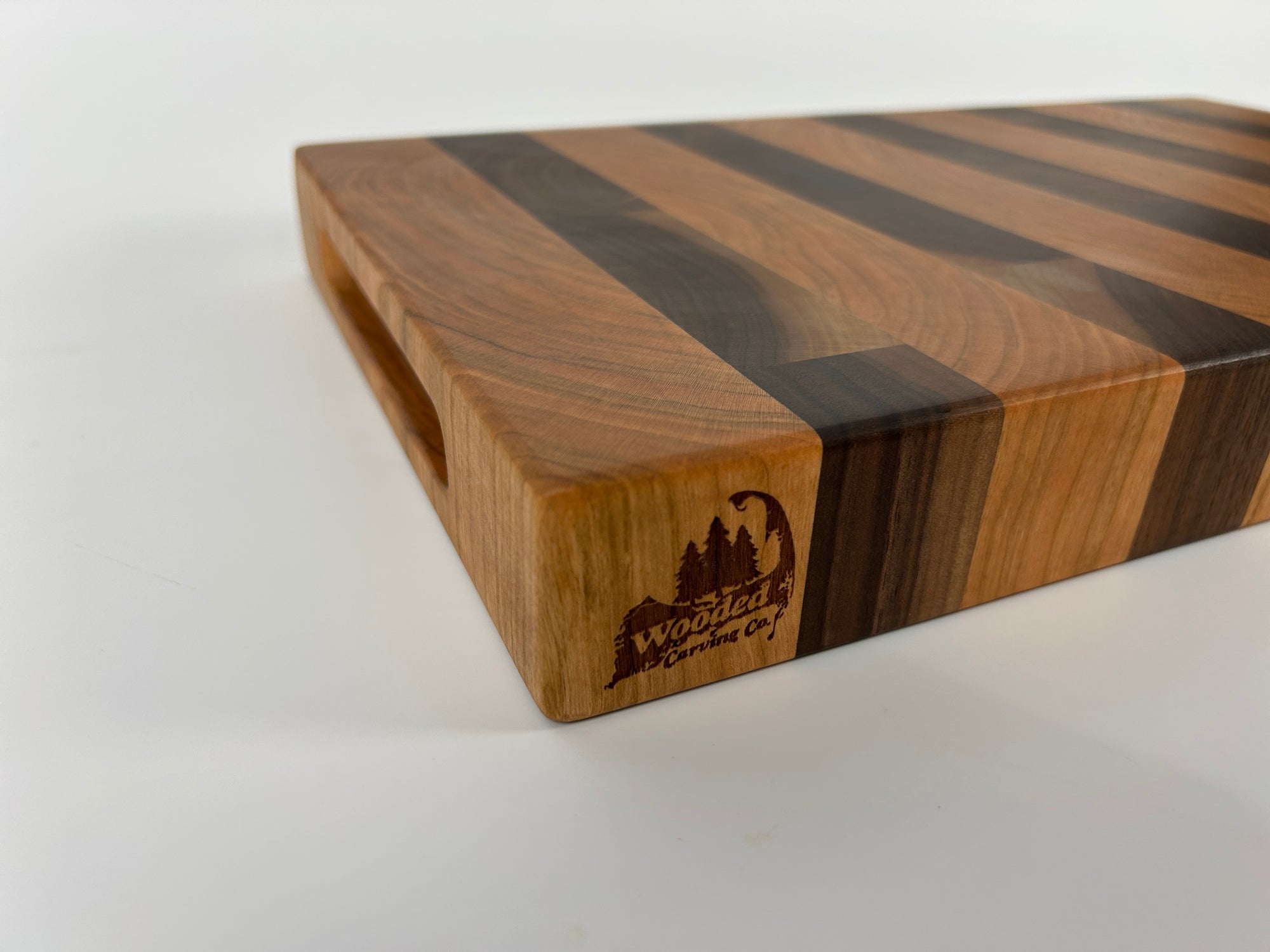 Wooden cutting board with a visible brand logo on a white background