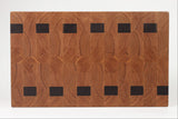 Wooden cutting board with a geometric pattern on a white background