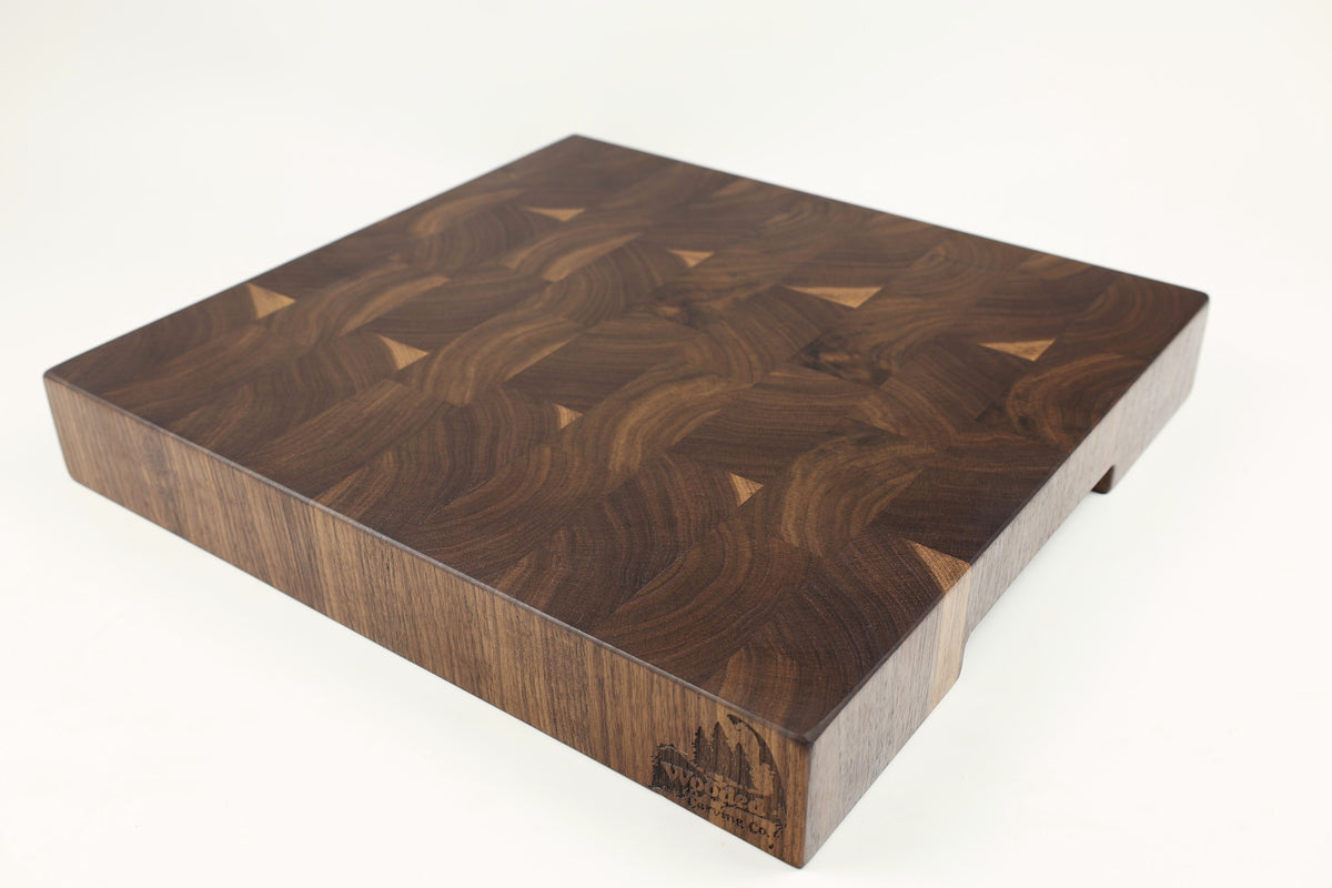Mid-angle hero shot of Choppy Waters — Walnut end-grain cutting board, 15″ × 16″ × 2.25″