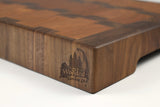 Corner detail of A Rocky Road showing the Wooded logo