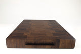 Handle-end view of Squares & Swirls, Walnut end-grain cutting board