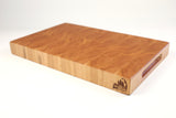 Mid-angle hero shot of Hearty Cherry — Cherry end-grain cutting board, 12″ × 18″ × 2″