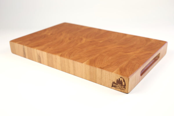 Mid-angle hero shot of Hearty Cherry — Cherry end-grain cutting board, 12″ × 18″ × 2″