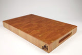 Mid-angle hero shot of Cherrantula — Cherry end-grain cutting board, 12.5″ × 20″ × 2″