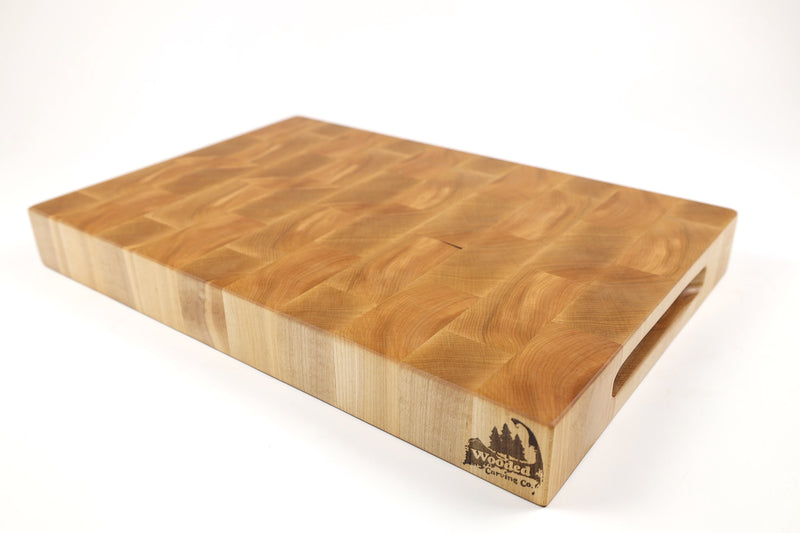 Mid-angle hero shot of Boomerangs — Maple end-grain cutting board, 11.5″ × 17.5″ × 2″