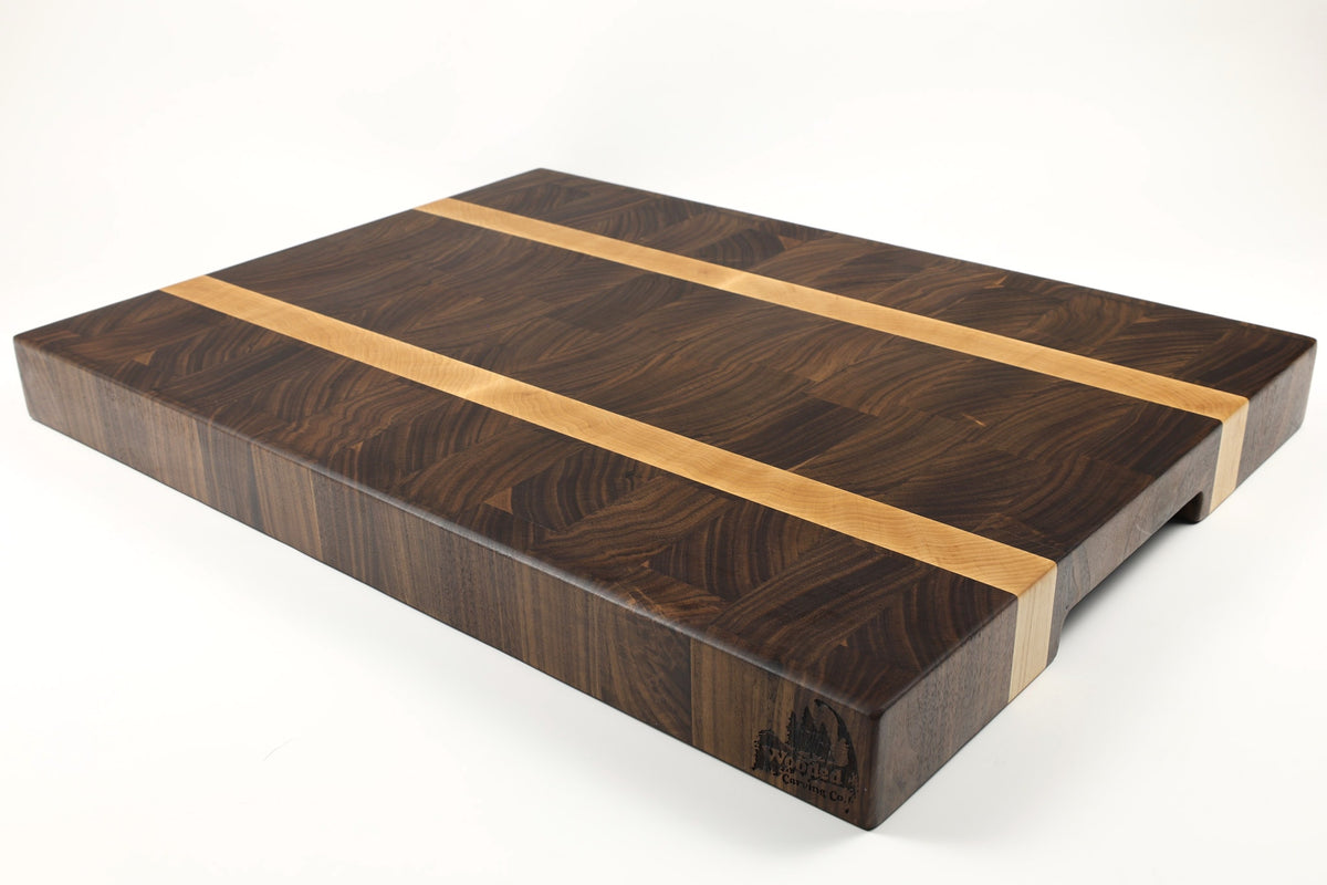 Mid-angle hero shot of Racer XL — Walnut and Maple end-grain cutting board, 18″ × 24″ × 2.25″