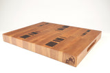 Mid-angle hero shot of Five Cylinders — Cherry and Walnut end-grain cutting board, 15″ × 19″ × 2″