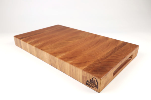 Mid-angle hero shot of Cherry Slices — Cherry end-grain cutting board, 11″ × 19″ × 2″