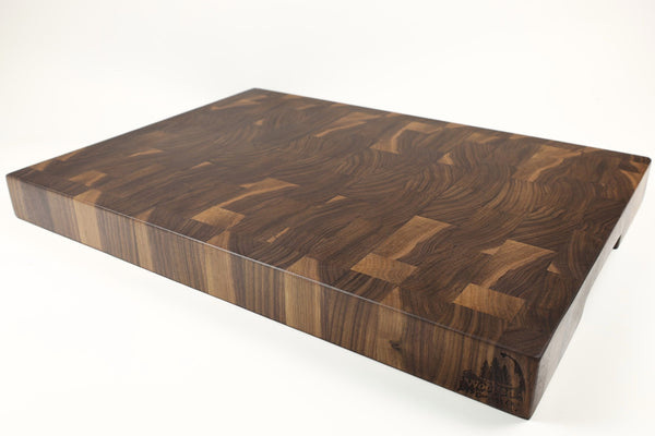 Mid-angle hero shot of Lacey Grains — Walnut end-grain cutting board, 18″ × 24″ × 2.25″