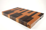 Mid-angle hero shot of Keys — Walnut and Cherry end-grain cutting board, 14″ × 21″ × 2″