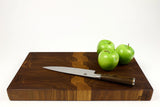Side mid-angle of Grainy Gorge with knife and fruit for scale