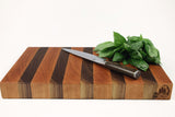 Side mid-angle of Walnut & Cherry Single No. 2 with knife and fruit for scale