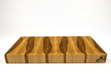 Side mid-angle of BoardHickory28 with knife and fruit for scale