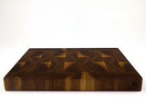 Side mid-angle of Patterned Planks with knife and fruit for scale