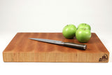 Side mid-angle of BoardCherry35 with knife and fruit for scale