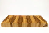 Side mid-angle of BoardHickory29 with knife and fruit for scale