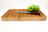 Side mid-angle of Board Single - MapleMagic with knife and fruit for scale
