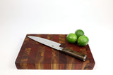 Side mid-angle of Canary Sunset with knife and fruit for scale