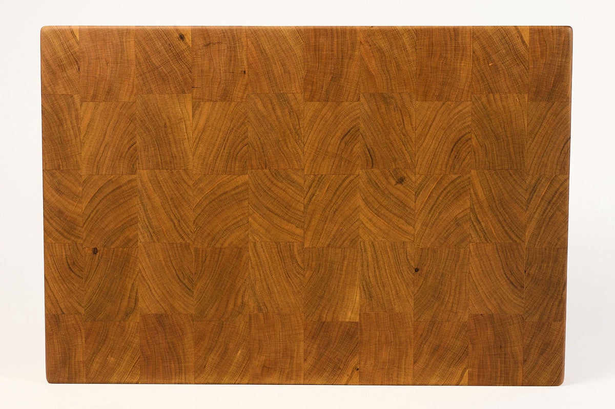 Wooden cutting board with a wavy grain pattern on a white background